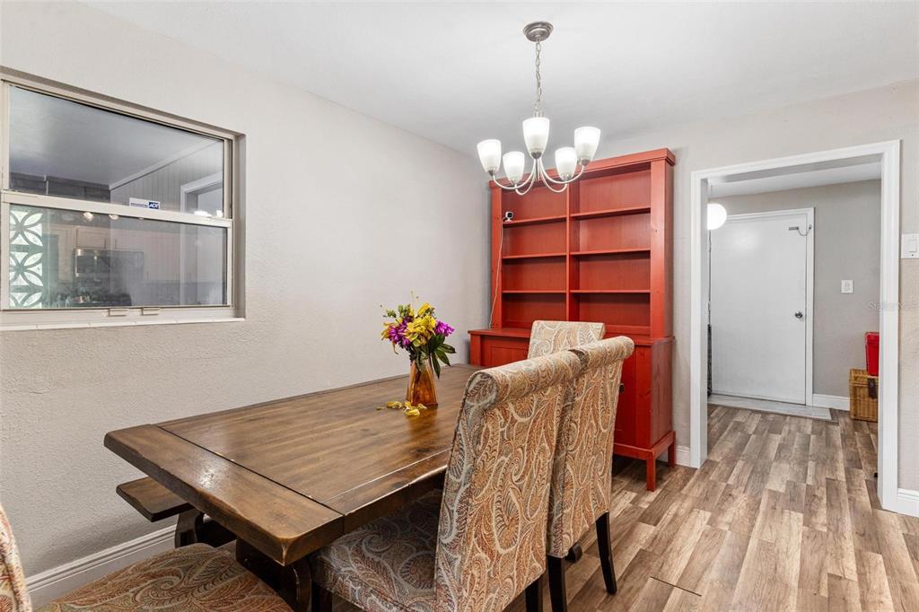398 Rose Street Umatilla, FL 32784 - Photo 8 of 30 a dining room with furniture a rug and wooden floor