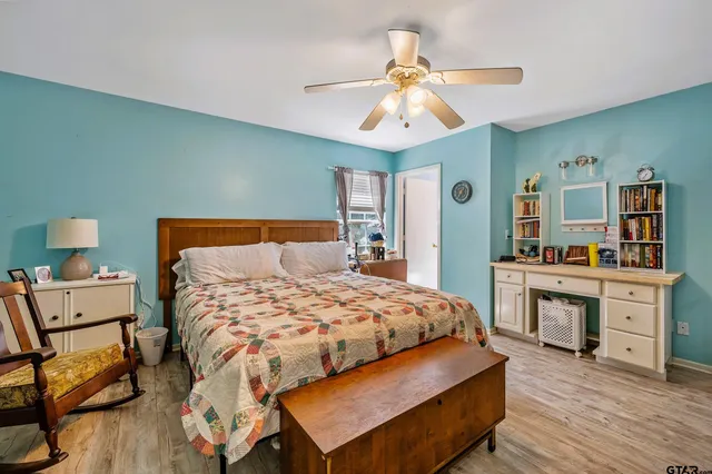 a bedroom with a bed and wooden floor