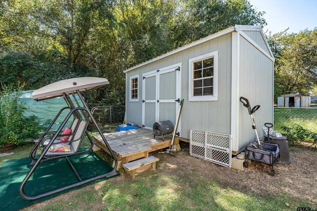a backyard of a house with table and chairs