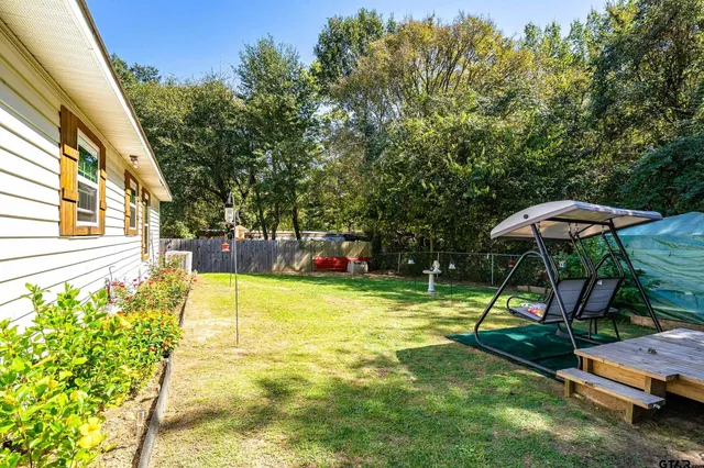 a view of a backyard with a table and chairs