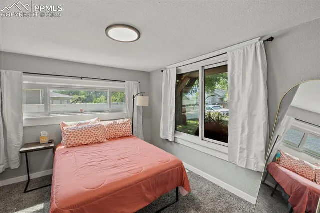 a bedroom with a large bed and a large window