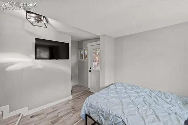 a bedroom with a bed and a flat screen tv