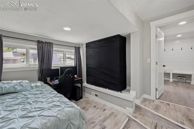 a bedroom with a bed and a television on desk