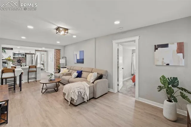 a living room with furniture and a potted plant