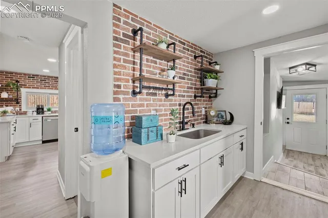 a kitchen with sink and cabinets