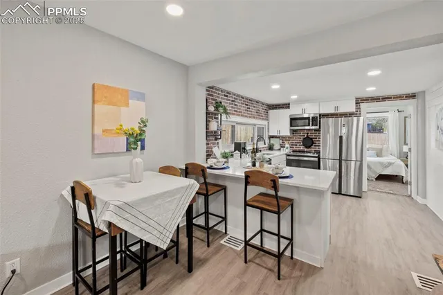 a view of a dining room with furniture and wooden floor