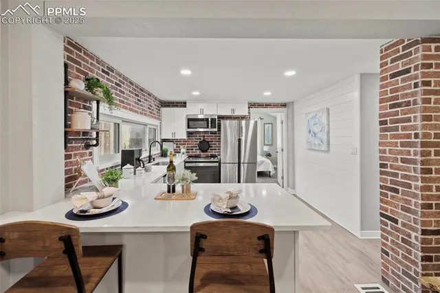 a kitchen with a table and chairs