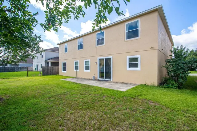an aerial view of a house with a yard basket ball court and outdoor seating
