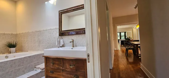 a white toilet sitting next to a bathroom sink and tub