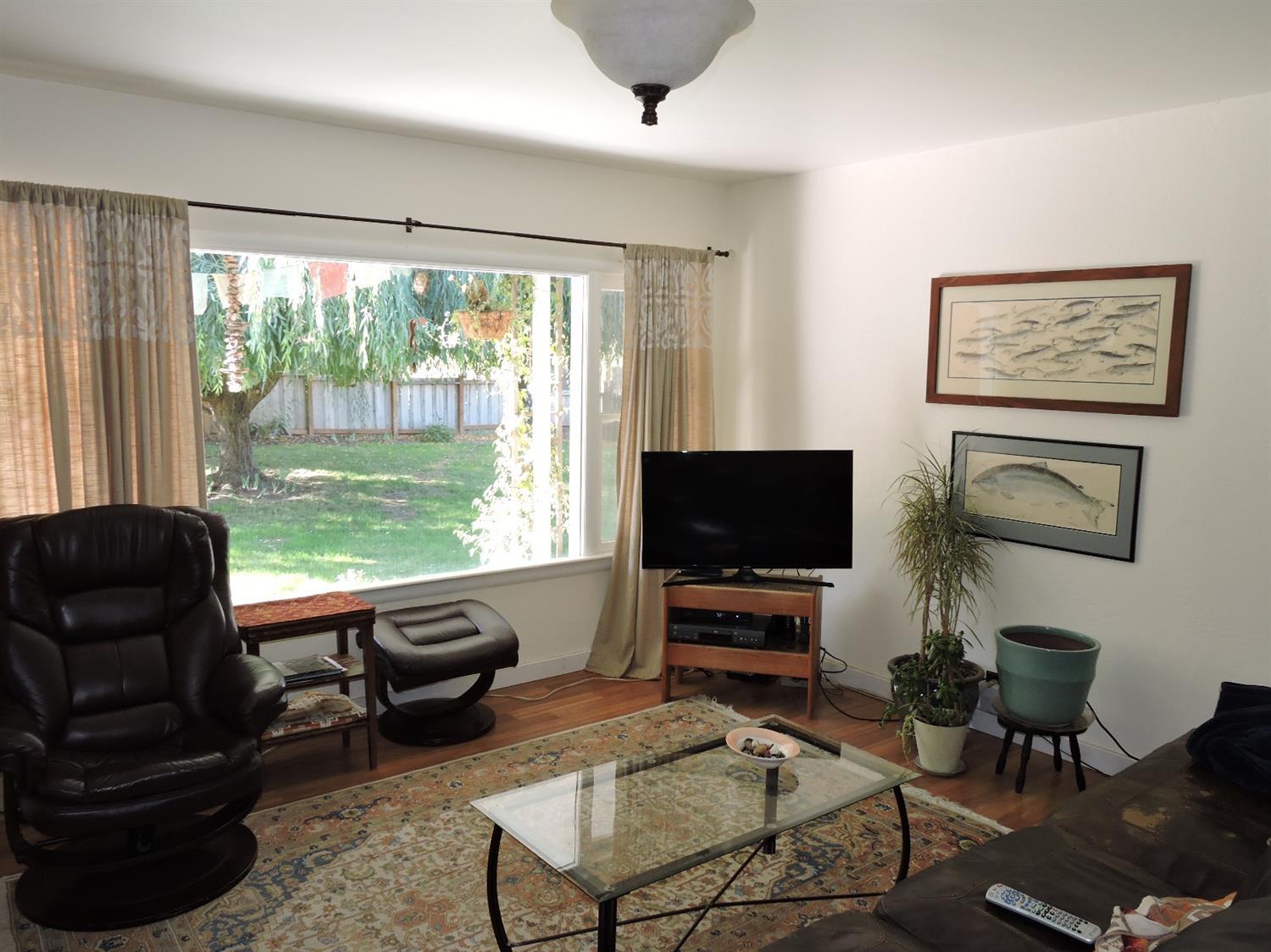 7233 Wagner Creek Road Talent, OR 97540 - Photo 5 of 27 a living room with furniture and a flat screen tv