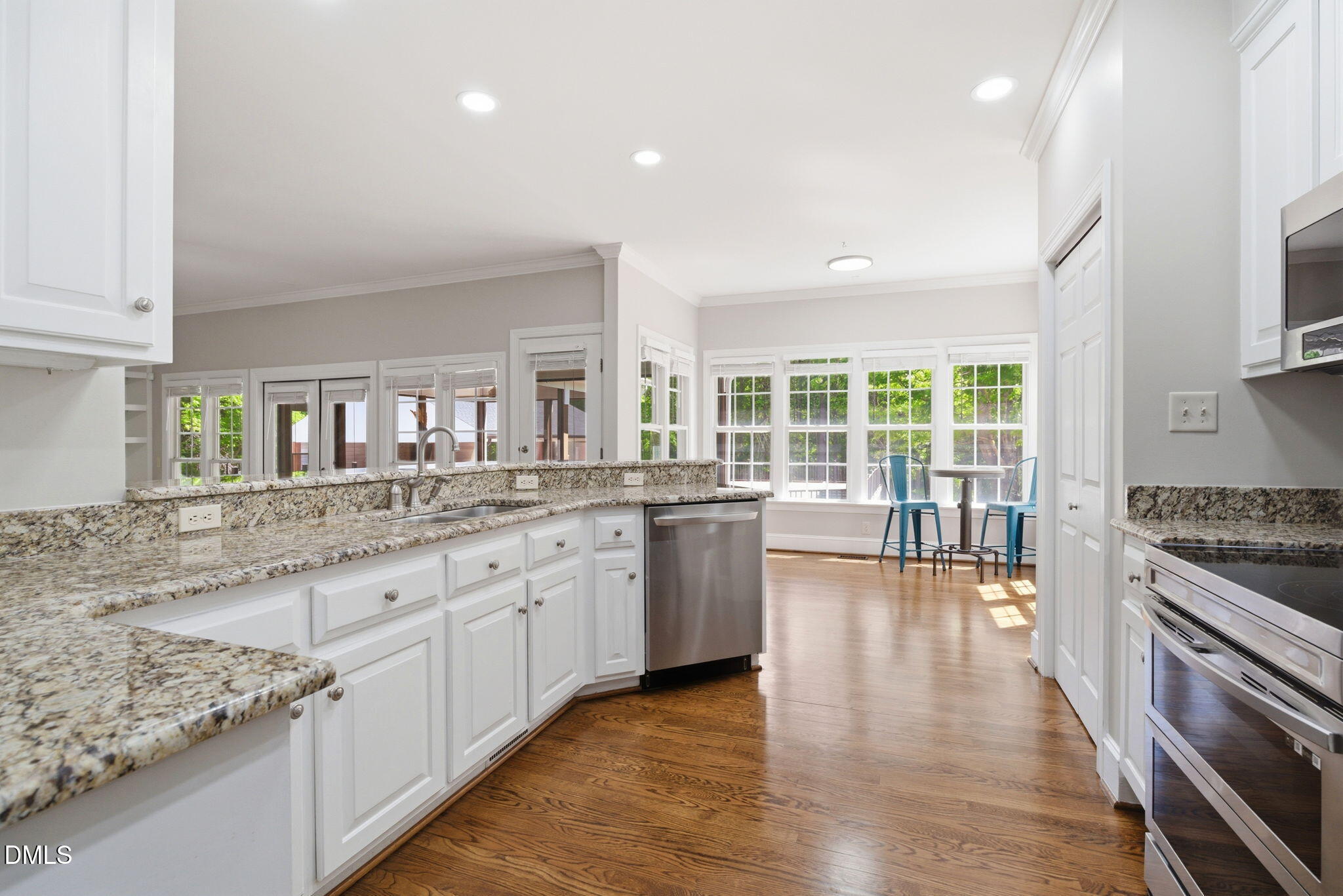 5416 Pulley Town Road Zebulon, NC 27597 - Photo 18 of 74 a large kitchen with granite countertop a stove top oven a sink a dining table and chairs
