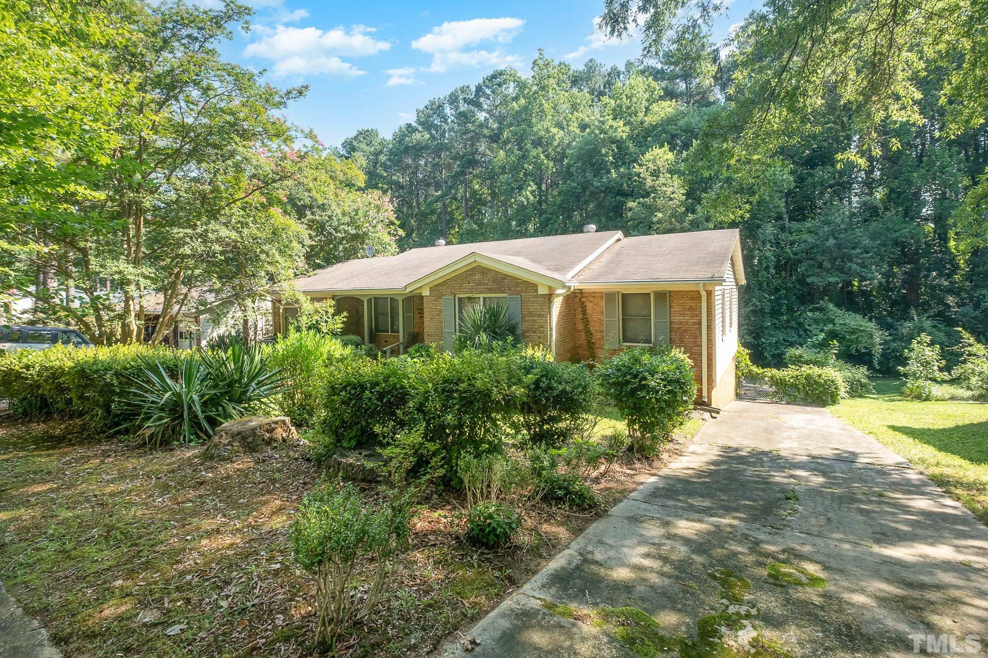 2409 Foxtrot Road Raleigh, NC 27610 - Photo 1 of 14 a view of a house with a yard and potted plants
