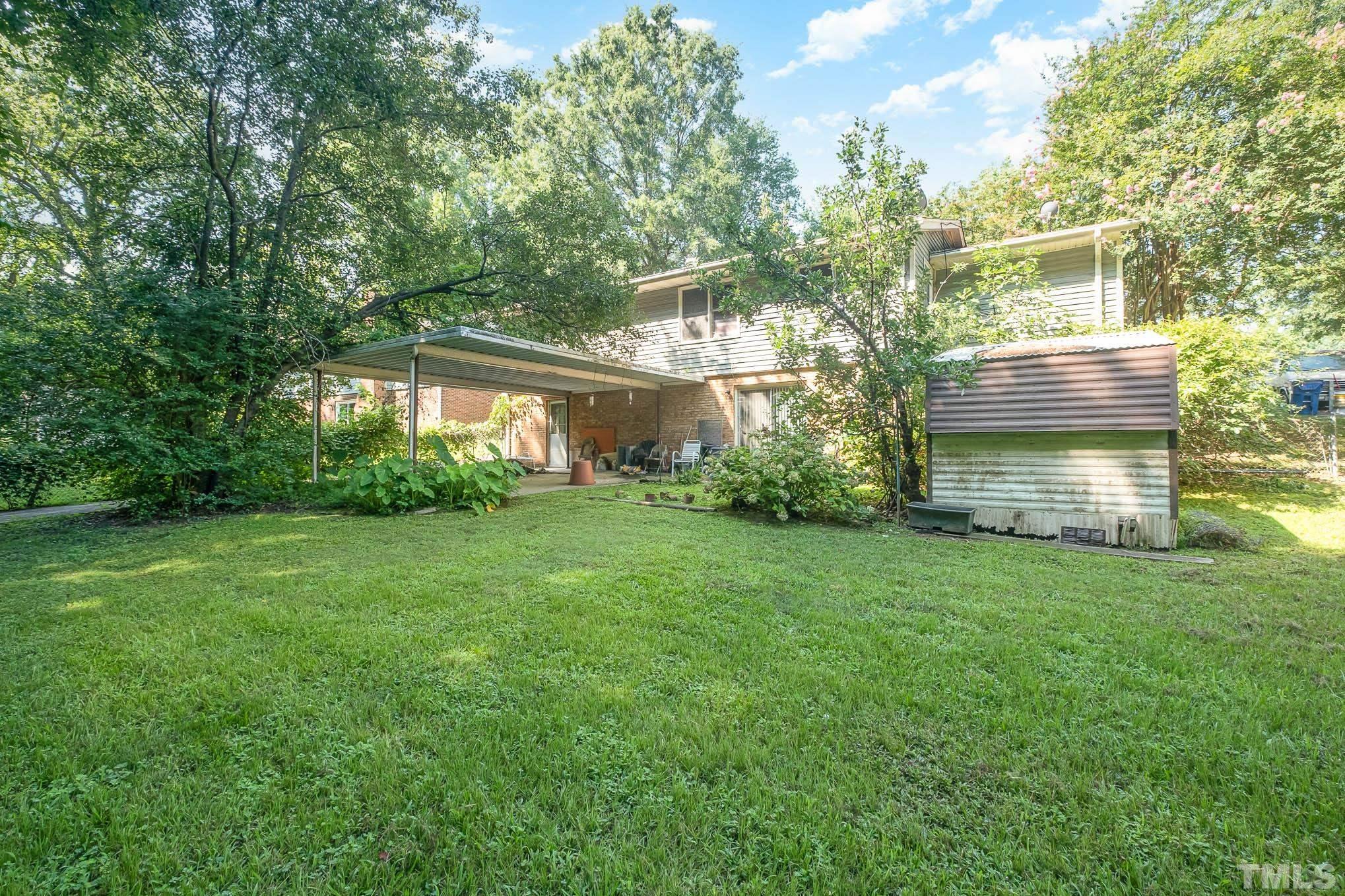 2409 Foxtrot Road Raleigh, NC 27610 - Photo 11 of 14 a view of a house with backyard and garden