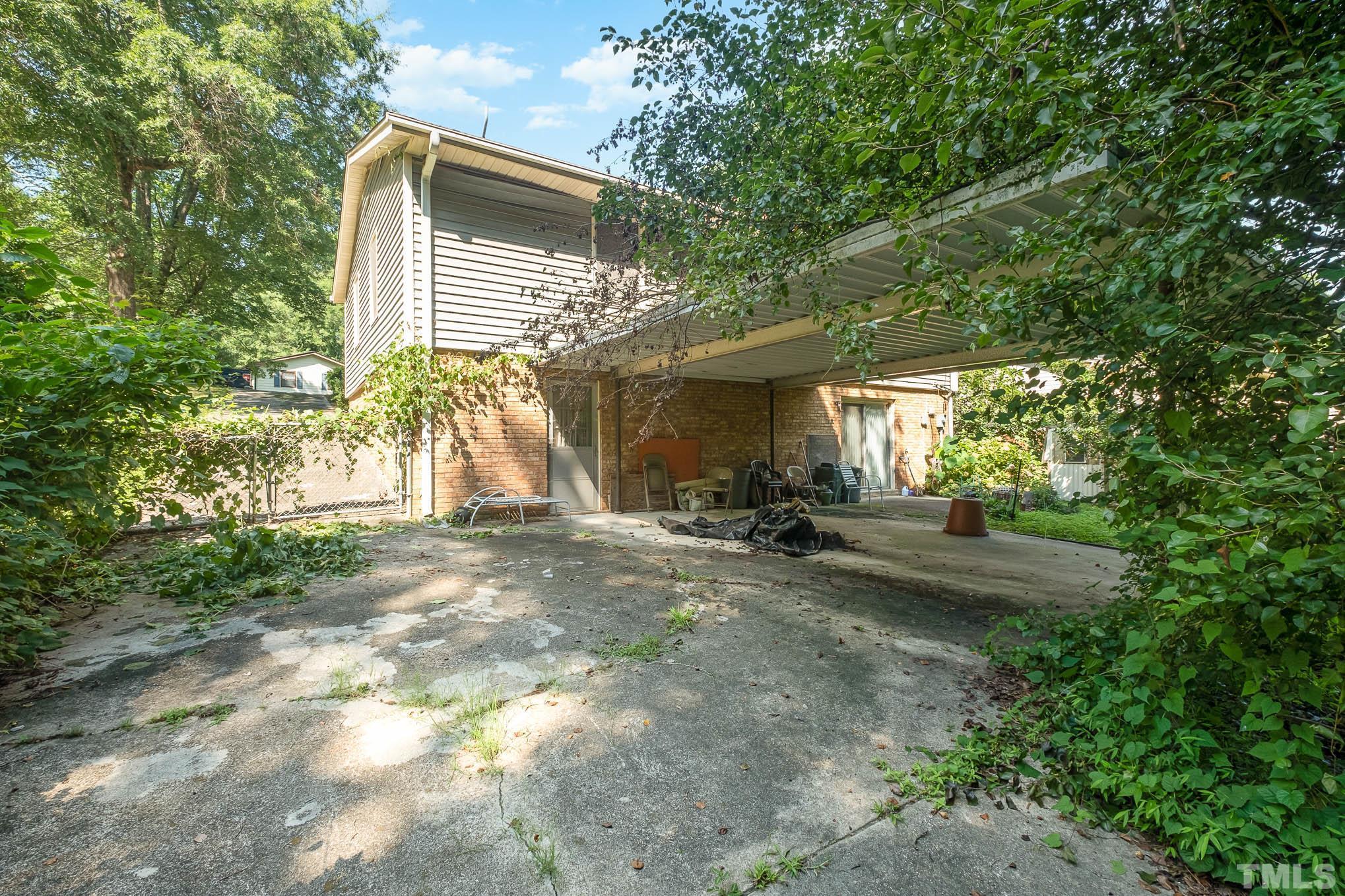 2409 Foxtrot Road Raleigh, NC 27610 - Photo 13 of 14 a view of a house with backyard and a tree