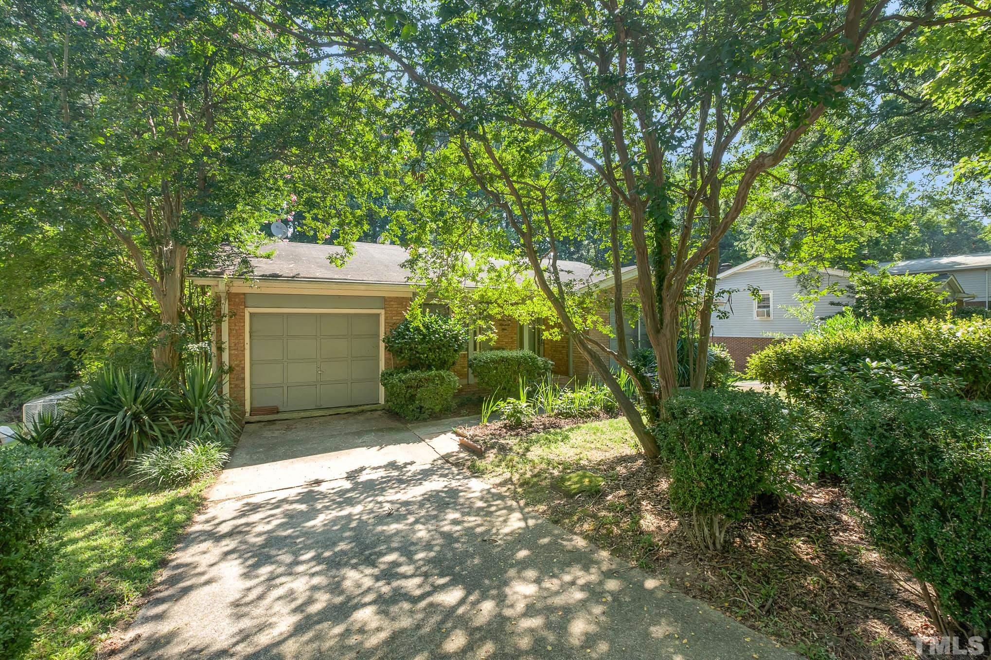 2409 Foxtrot Road Raleigh, NC 27610 - Photo 3 of 14 a view of a house with a yard and garage