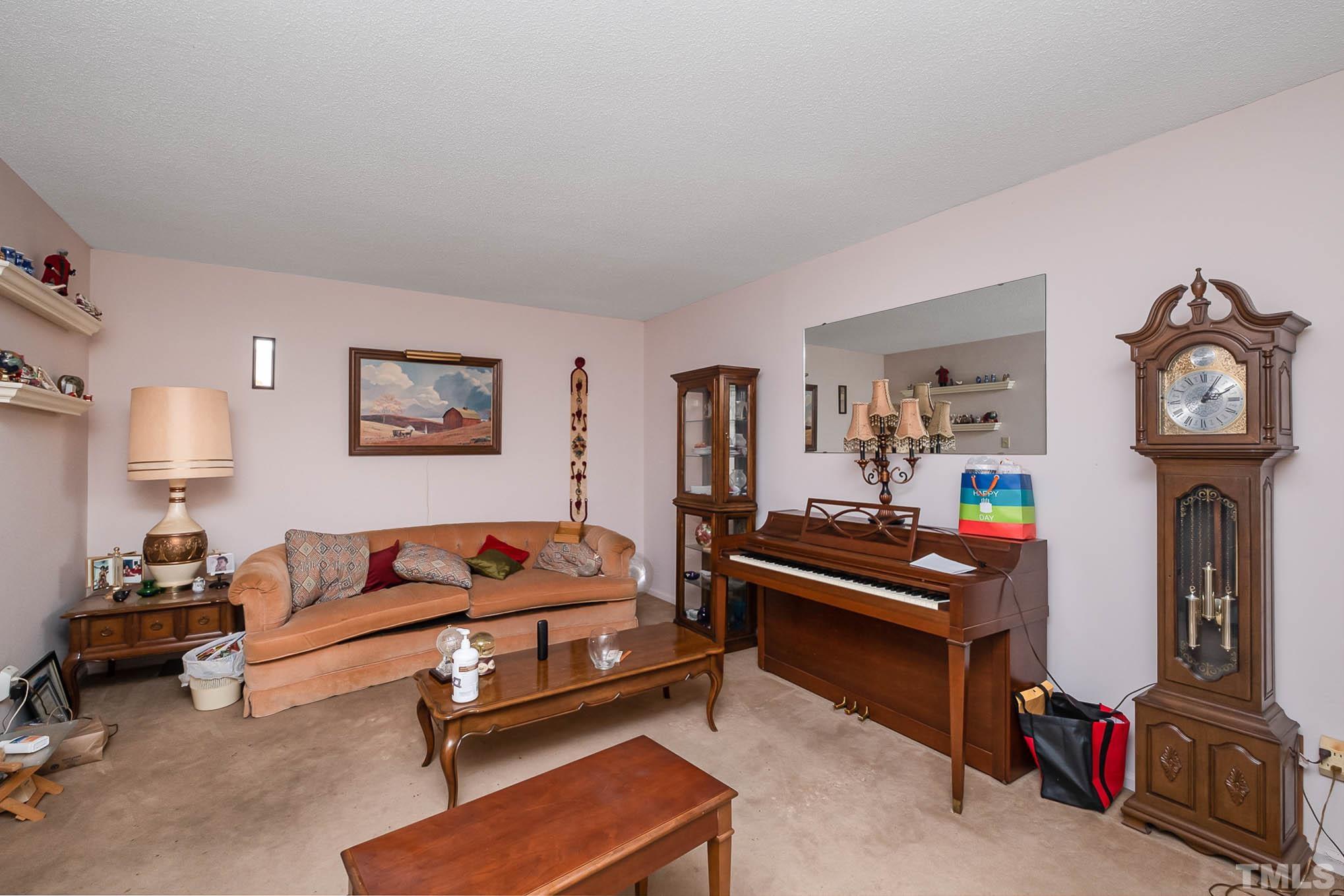 2409 Foxtrot Road Raleigh, NC 27610 - Photo 6 of 14 a living room with furniture and a lamp