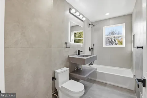 a bathroom with a toilet a sink and bathtub