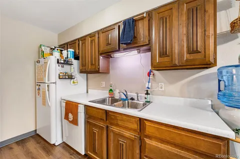 a kitchen with stainless steel appliances a sink a refrigerator and cabinets