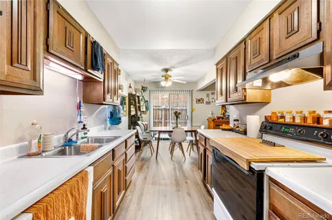 a kitchen with stainless steel appliances granite countertop lots of counter top space and wooden floor