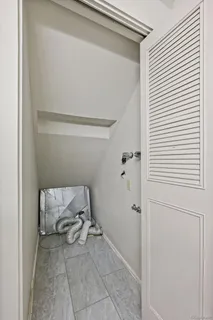 a view of room with chair and wooden floor