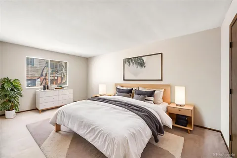 a bedroom with a bed and window