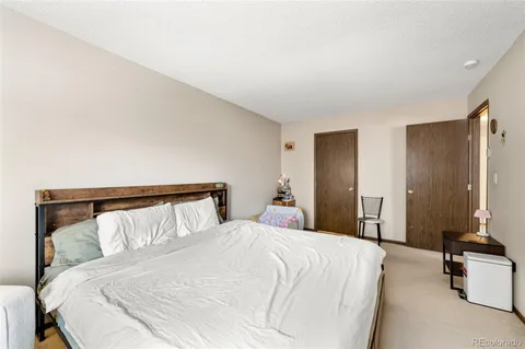 a bedroom with a bed and a couch