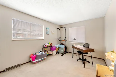 a bedroom with furniture and a window