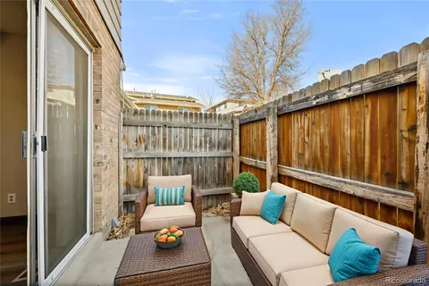 a balcony with furniture and a potted plant