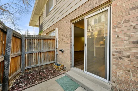 a view of a wooden door with a bench
