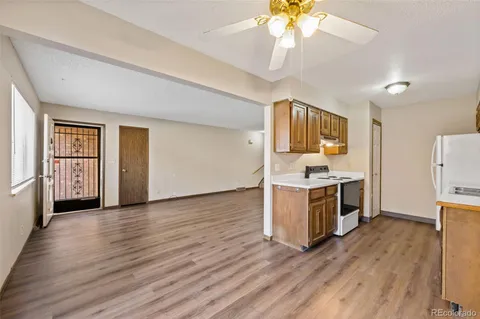 a kitchen with a refrigerator and a stove top oven
