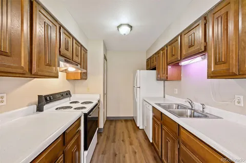 a kitchen with stainless steel appliances a sink stove and cabinets