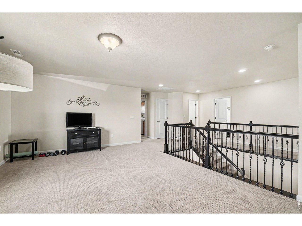 1124 Wagon Bend Road Berthoud, CO 80513 - Photo 15 of 38 2nd story loft/rec room facing 3 bedroom, laundry room, linen close, shared full bathroom, and bedroom 2