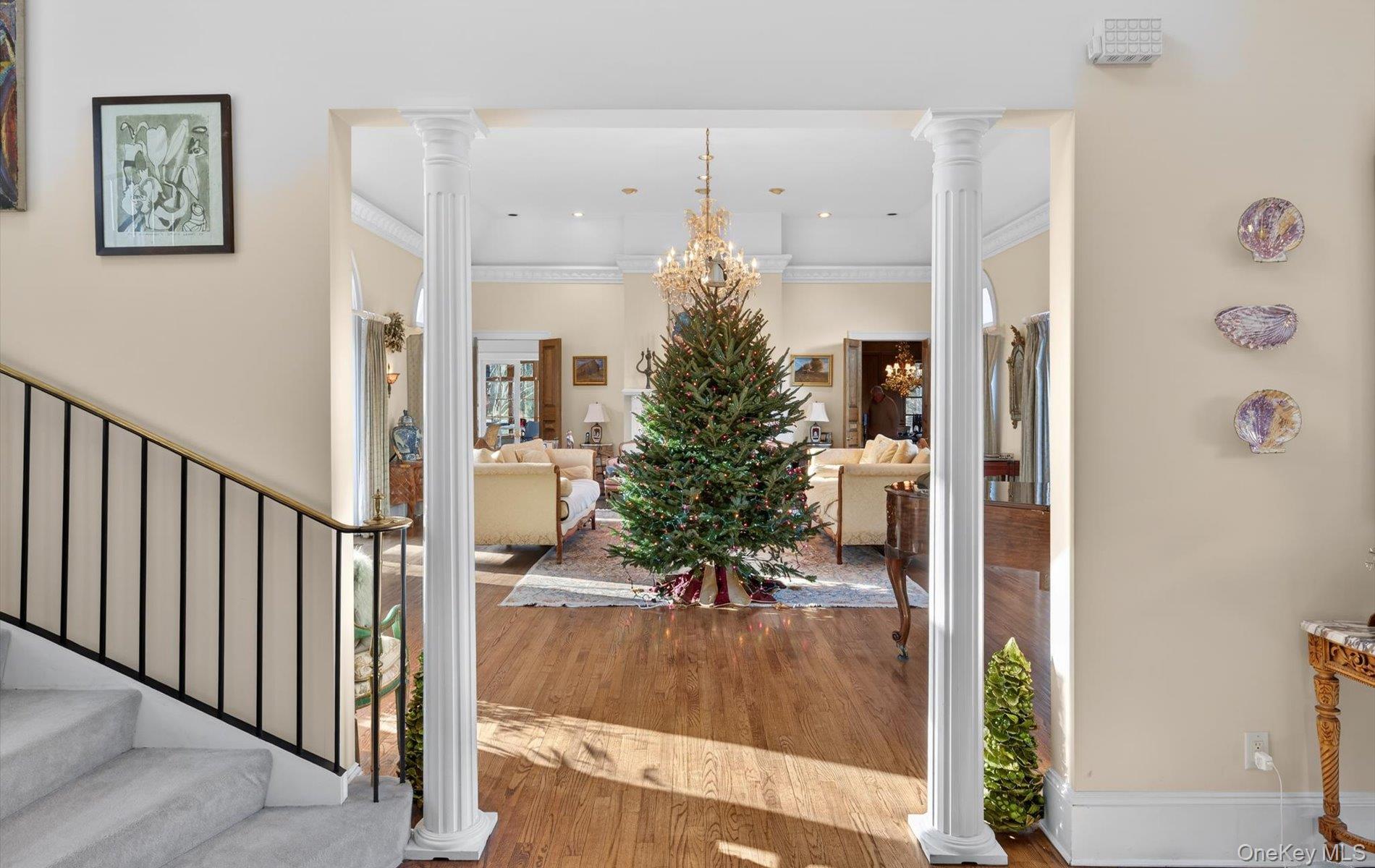 38 Tiffany Road Oyster Bay, NY 11771 - Photo 11 of 50 Foyer entrance with decorative columns, wood finished floors, ornamental crown molding,