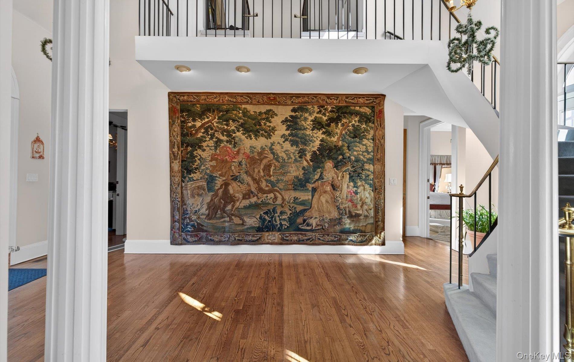 38 Tiffany Road Oyster Bay, NY 11771 - Photo 12 of 50 Entrance foyer featuring a high ceiling, wood finished floors, and decorative columns