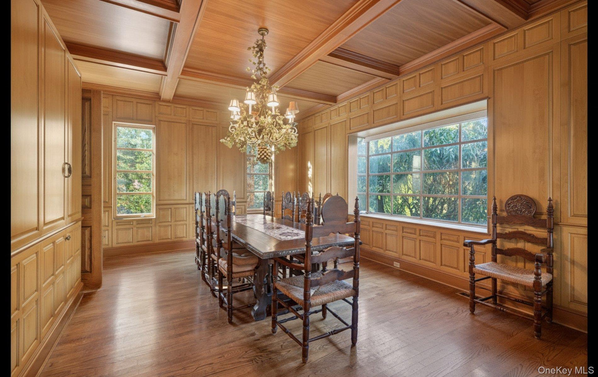 38 Tiffany Road Oyster Bay, NY 11771 - Photo 14 of 50 Dining room featuring wooden ceiling, a decorative wall, a chandelier, wood-type flooring, and coffered ceiling