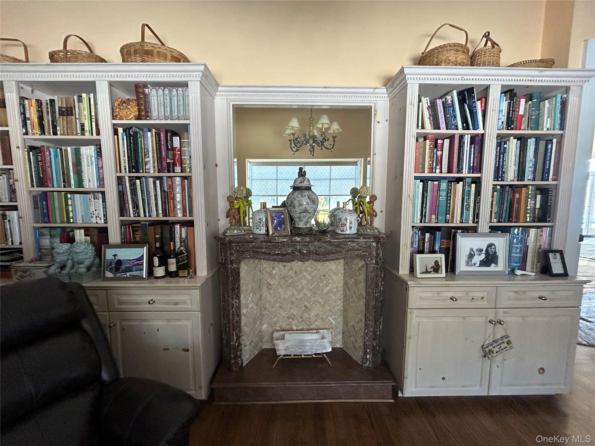 38 Tiffany Road Oyster Bay, NY 11771 - Photo 19 of 50 Library, Sitting room featuring dark wood finished floors , faux tiled fireplace, custom bookshelves