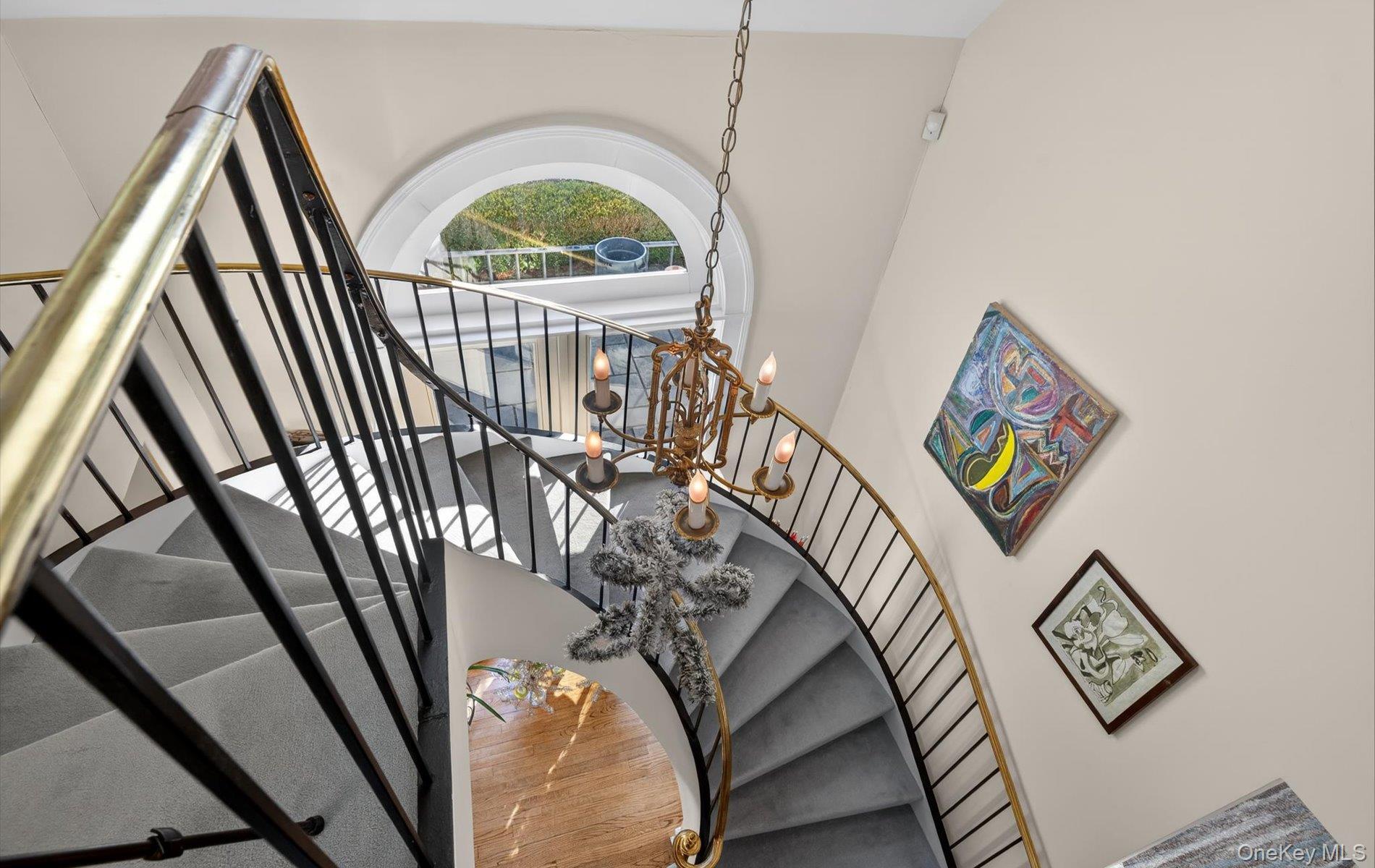 38 Tiffany Road Oyster Bay, NY 11771 - Photo 29 of 50 Dramatic cement Staircase featuring a chandelier and wood finished floors