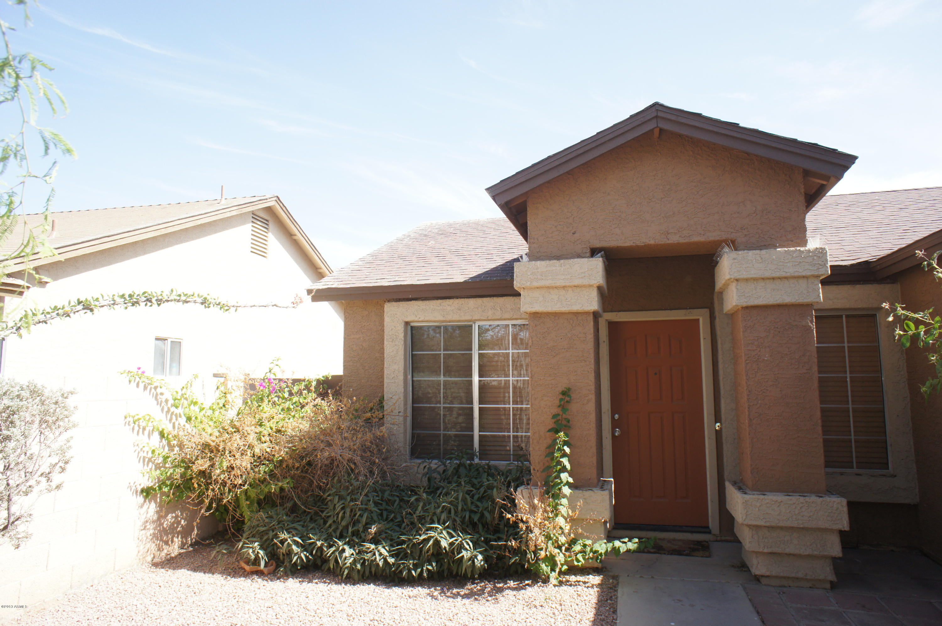 9011 West Granada Road Phoenix, AZ 85037 - Photo 7 of 7 a front view of a house with a yard
