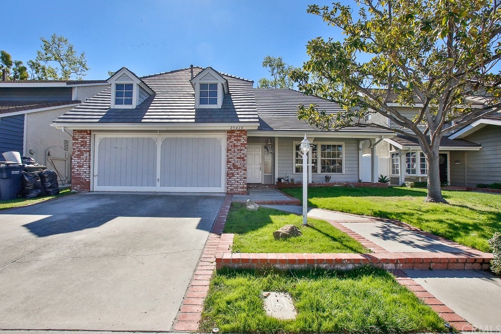 a front view of a house with a yard table and chairs