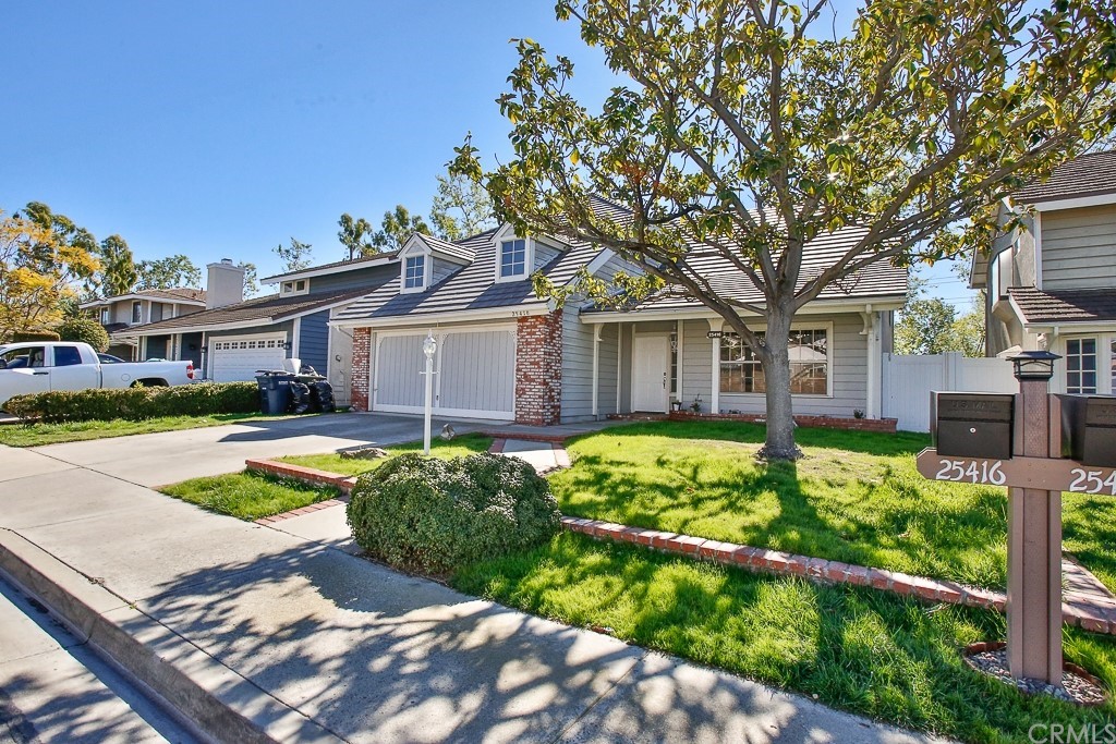 25416 Elderwood Lake Forest, CA 92630 - Photo 2 of 4 a front view of a house with a yard table and chairs