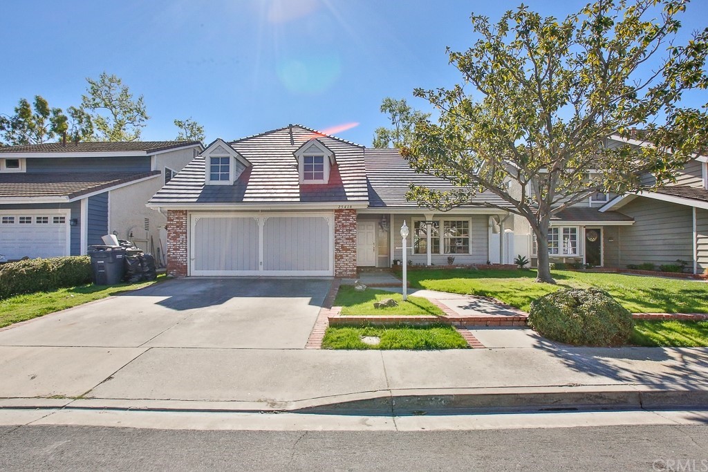 25416 Elderwood Lake Forest, CA 92630 - Photo 4 of 4 a front view of a house with a yard and potted plants