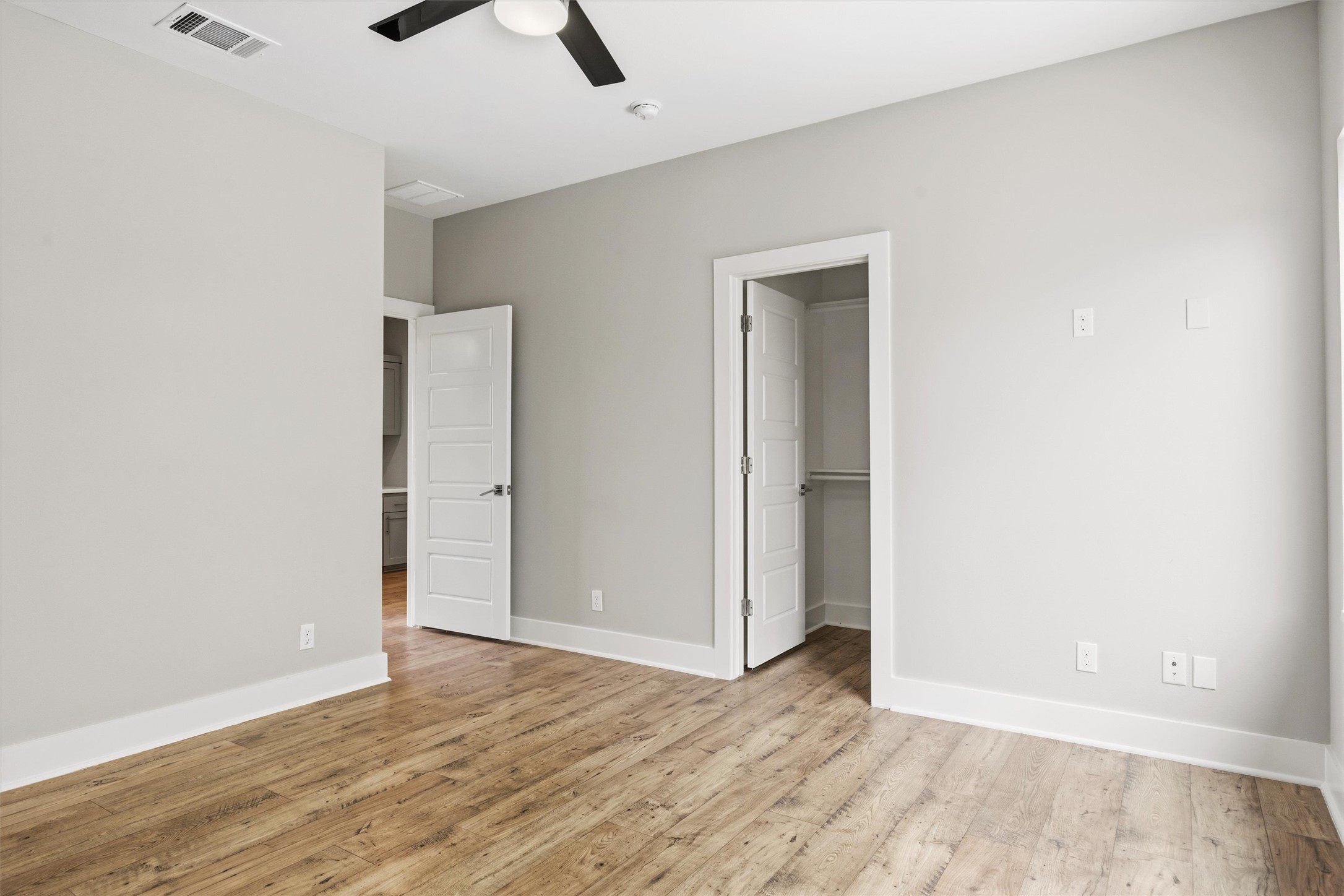 1210 Stobaugh Street, Unit B Austin, TX 78757 - Photo 11 of 40 A well-lit bedroom with durable hardwood-style flooring, ready for your personal touch.