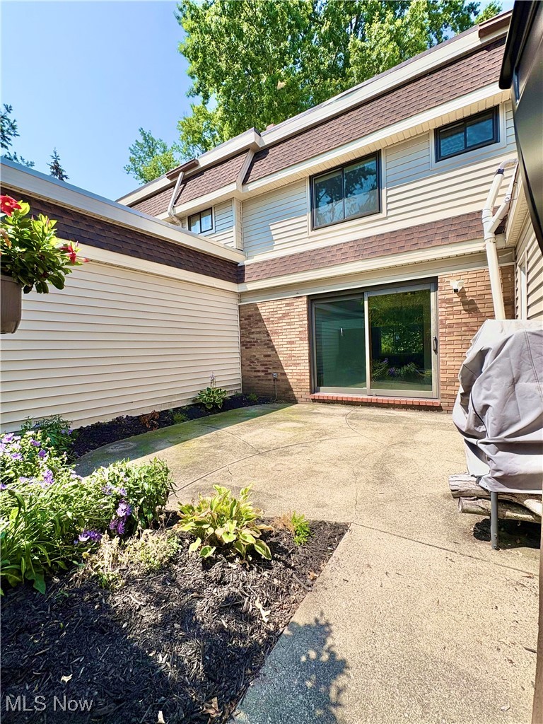 7050 Chillicothe Road, Unit C11 Mentor, OH 44060 - Photo 25 of 29 Rear view of house with a patio, brick siding, and roof with shingles