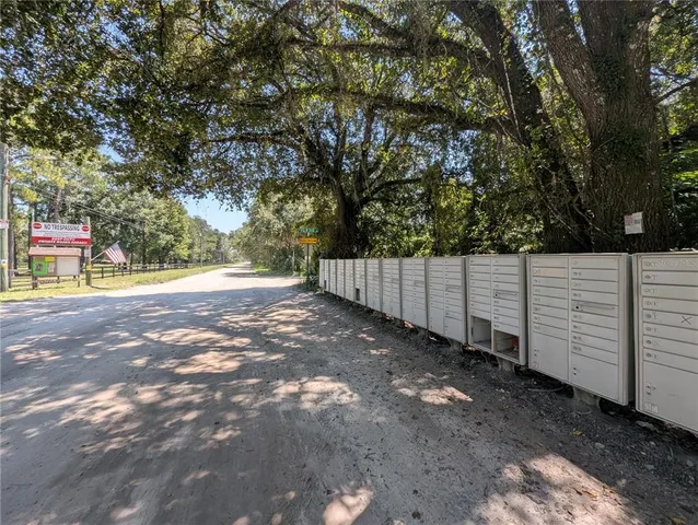 a view of backyard with wooden fence
