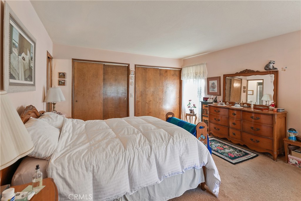 329 Grass Valley Road Lake Arrowhead, CA 92352 - Photo 21 of 31 a bedroom with a bed and wooden floor