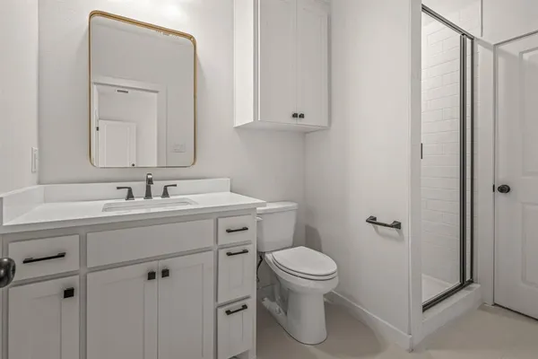 a bathroom with a sink mirror vanity and toilet