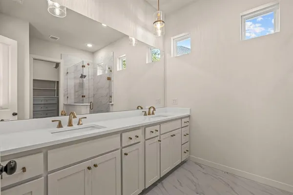 a bathroom with a double vanity sink and a mirror