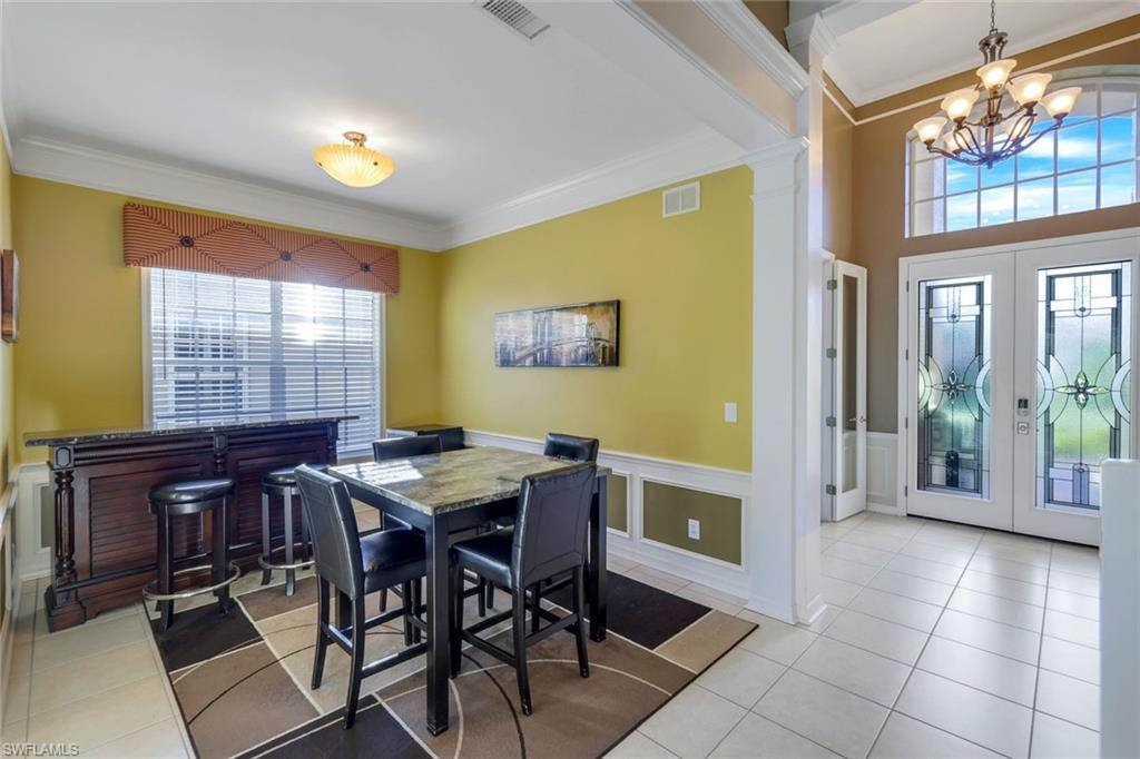 17896 Modena Road Miromar Lakes, FL 33913 - Photo 14 of 38 Formal Dining area, ornamental molding, spacious entry foyer with Distinctive Custom French Entry doors.