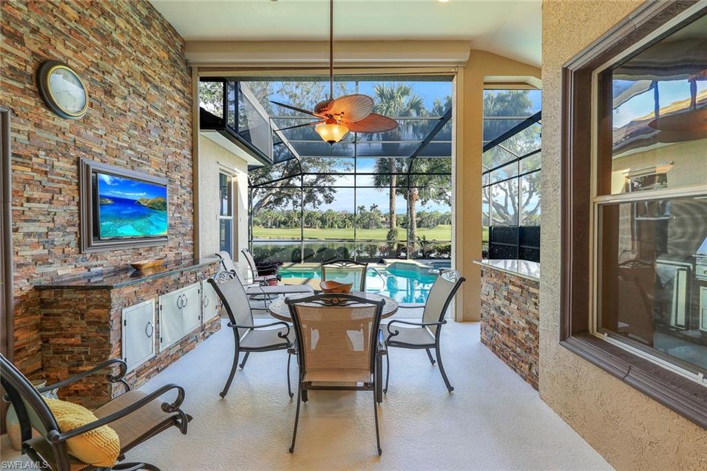 17896 Modena Road Miromar Lakes, FL 33913 - Photo 22 of 38 Covered Screened Lanai outdoor living area adjoining summer kitchen area overlooking pool, pond and golf course.