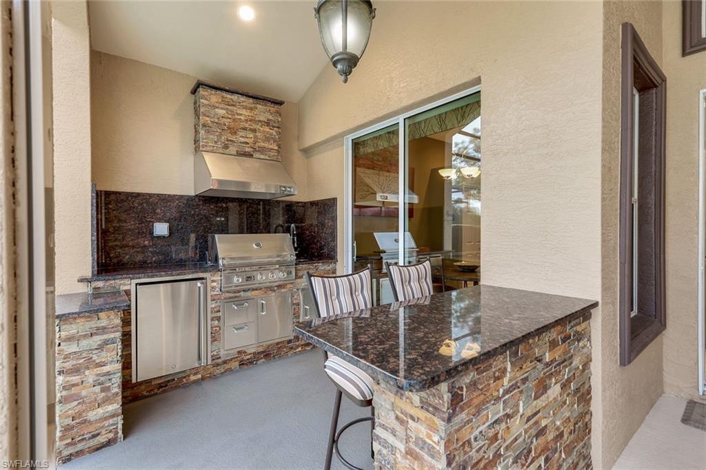17896 Modena Road Miromar Lakes, FL 33913 - Photo 23 of 38 Summer kitchen on screened lanai with grilling area, exterior bar